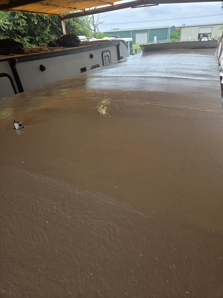 Freshly sealed RV rubber roof after repair